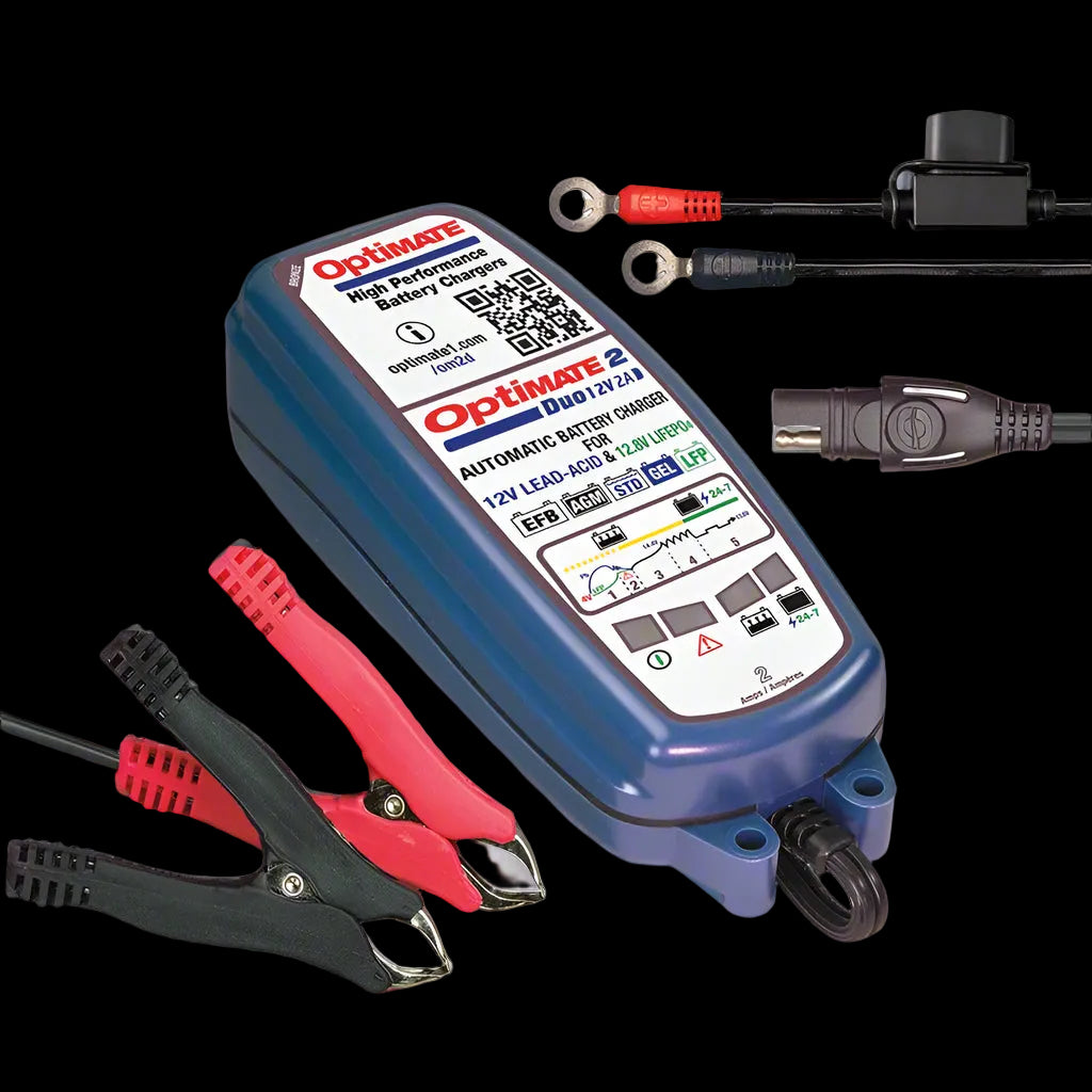 Optimate 2 battery charger with clamps on a gray background