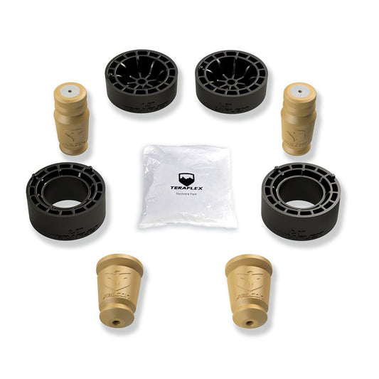 An assortment of Teraflex 1.5" Sport ST1 Spacer Lift System components laid out on a white background, including black coil spring spacers and beige bump stops.
